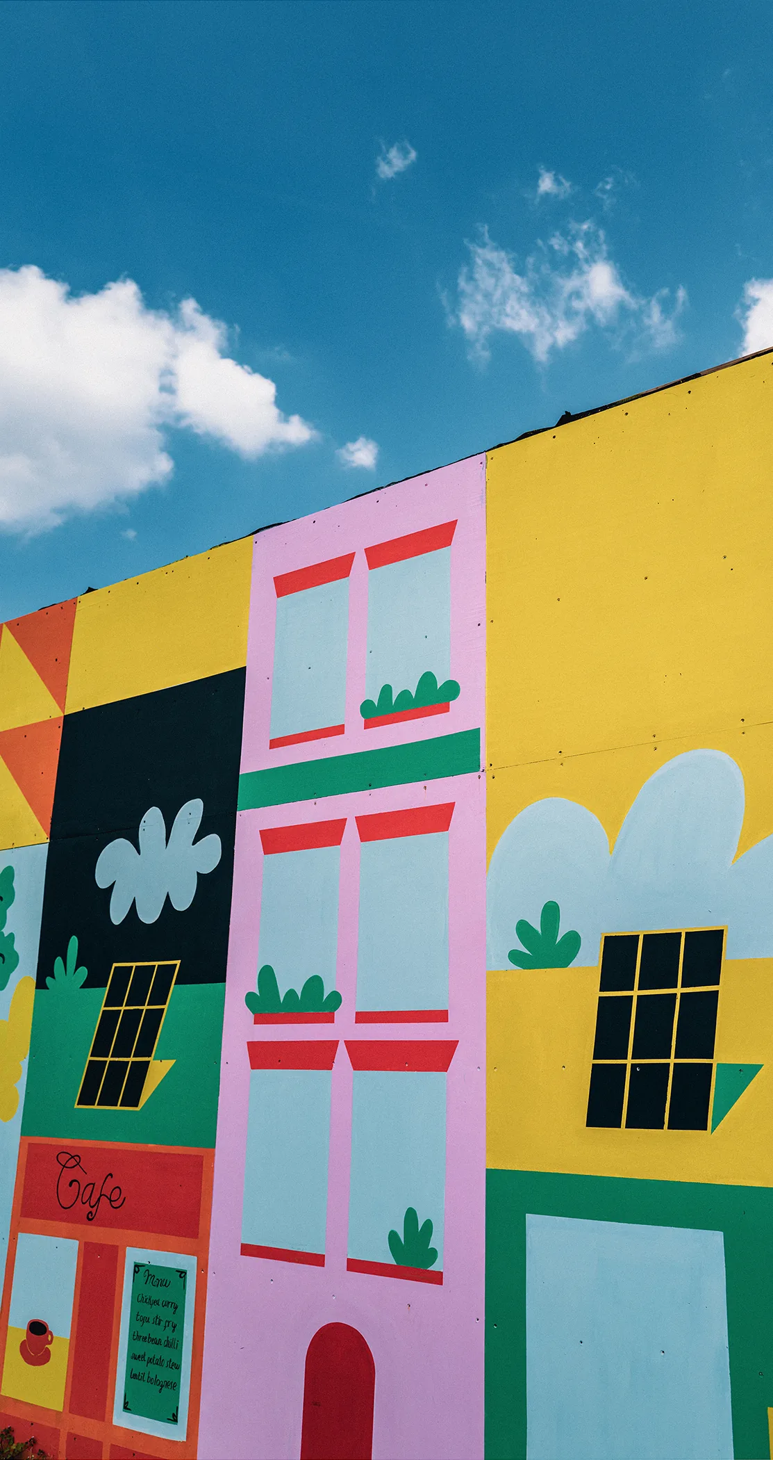 Hand-painted cloud mural on a building facade, Battersea