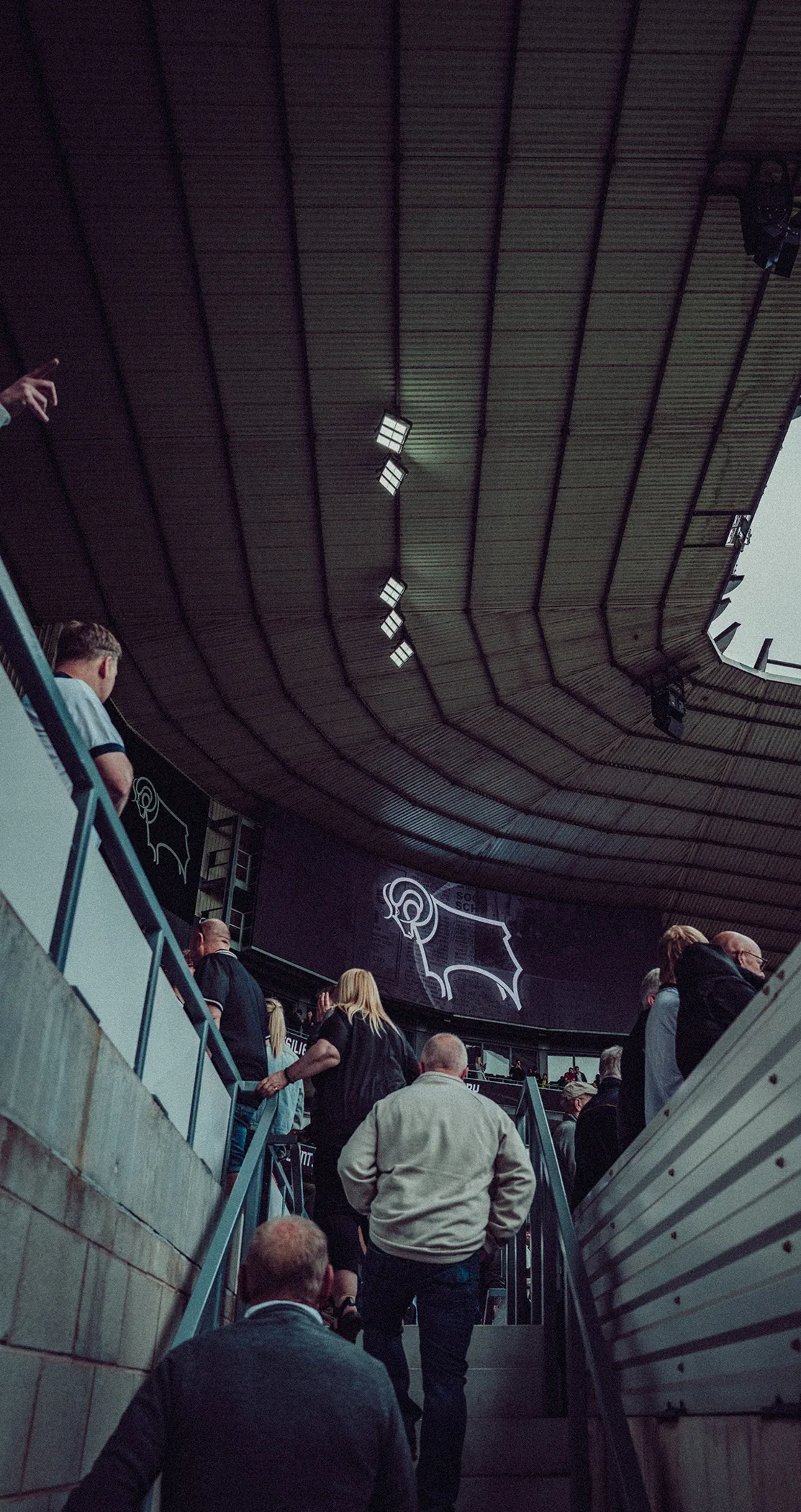 Fans climbing the stairs into the stand beneath the Derby County ram